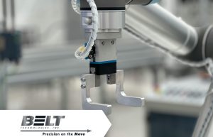 close up of robotic arm in front of a conveyor system